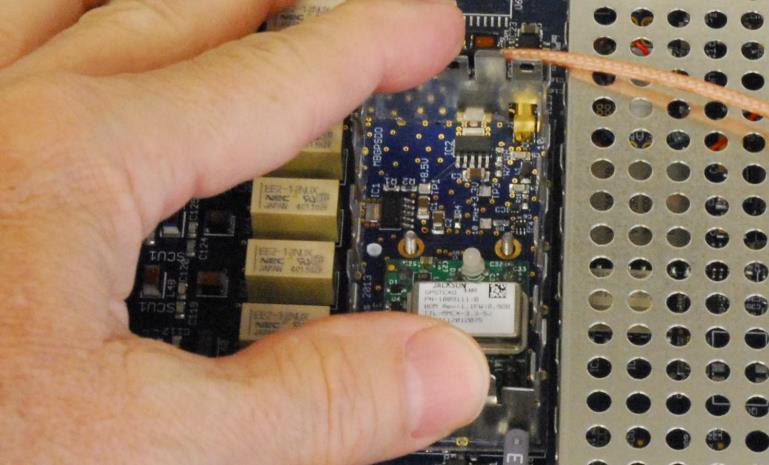Insert the GPSDO module assembly onto the PC board so that the two (2) threaded screw studs are