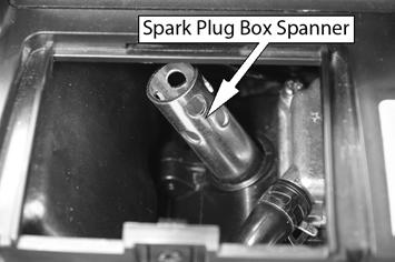 Fit the spark plug box spanner over the spark plug as shown.