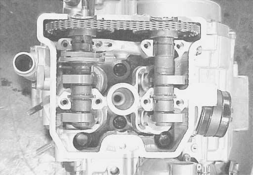 " If the crankshaft is turned without drawing the cam chain upward, the cam chain will catch between crankcase and cam chain drive sprocket.