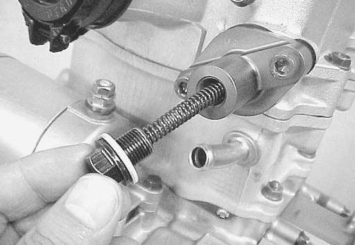 Install the new gasket and cam chain tension adjuster to the cylinder.