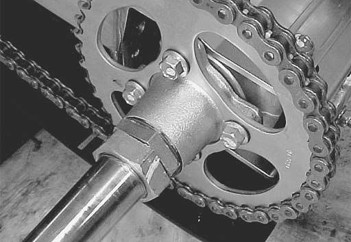 Loosen the chain adjust nuts 1 and the rear axle housing bolts 2. Loosen the sprocket mounting bolts, and remove the sprocket 3.