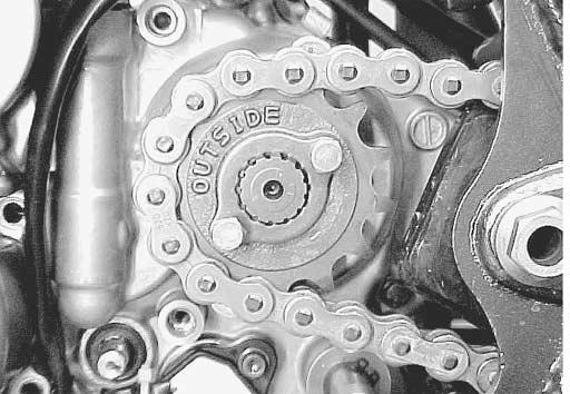 3-8 ENGINE Install the engine sprocket with drive chain after loosening the chain adjuster bolts. NOTE: The letter A on the engine sprocket should face to the outside.