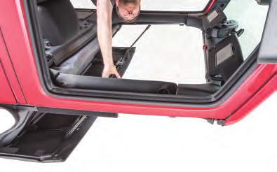 Grab the Flip Top Center Grab Handle and gently fold back the top structure towards the back of the vehicle.