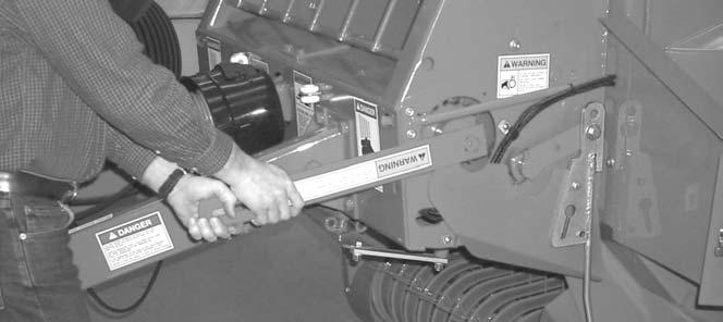 Chapter 5 - Operation Reversing Wrench (Figs. 8 & 9) The round baler is provided with a reversing wrench for manually rotating the transmission output shaft.