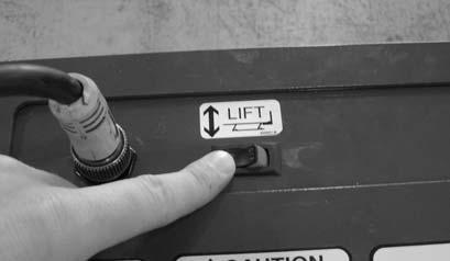 (See Figure 36.) 4. Depress and hold DOWN button on hand-held control unit to lower machine into mechanical stops. (See Figure 37.