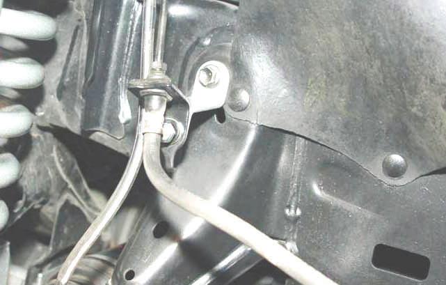 Install rotor and brake caliper using a 17mm wrench. 48. Install the stock brake line bracket onto the knuckle as shown in Photo 39 using the stock hardware. Tighten using 12mm wrench. 49.