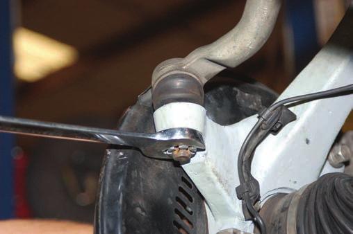 It may be necessary to slightly pull the ABS wire to create slack. WD-40 can be used to lub the line to allowit to slide in the upper control arm mount.
