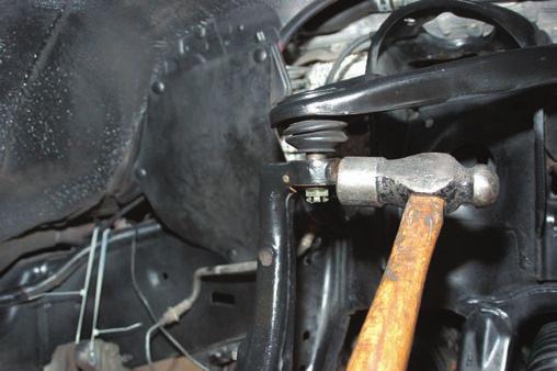 Using a hammer as shown in Photo 8, loosen ball joint from knuckle. Support the lower arm with jack stand. Photo 7 Photo 8 10.