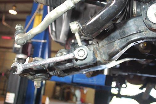 Remove sway-bar bolt from lower control arm using a 19mm wrench as shown in Photo 10. Photo 9 Photo 10 12.