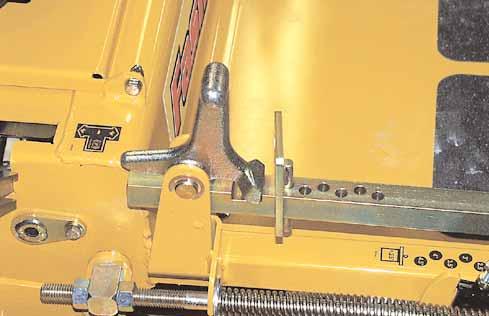 Stop handle Height adjusting stop Top hole Chain Middle hole Figure 3-14 Lower hole onto a previously cut area with the blades engaged.