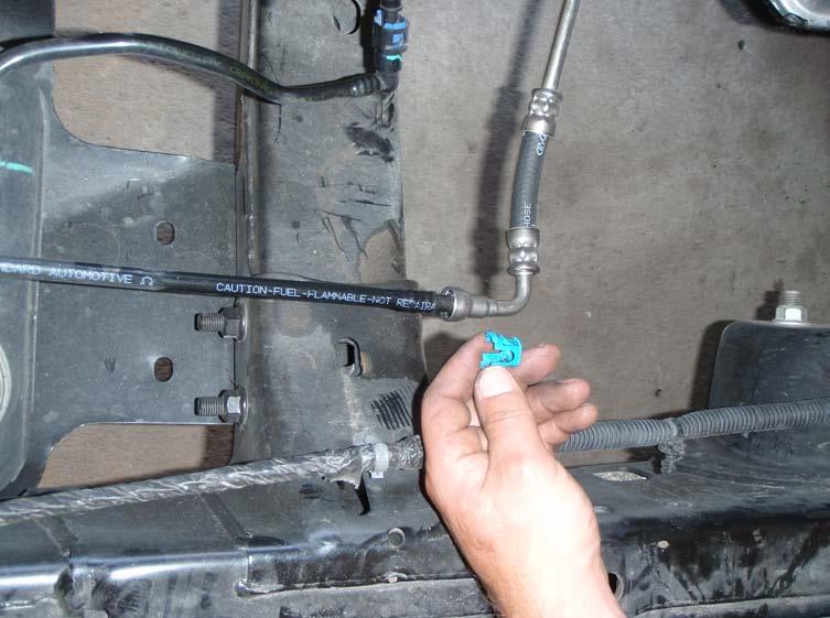 A. AEV HEMI FUEL LINE 1. Remove the locking clip out of the plastic fuel line at the tank as shown. 2.