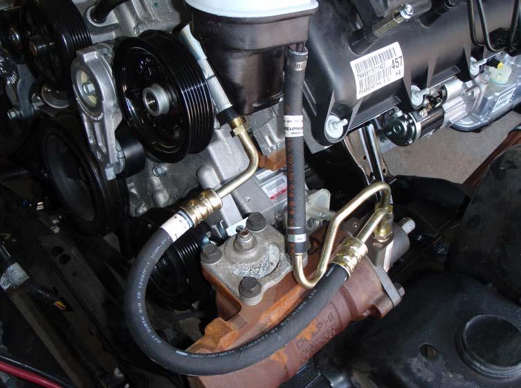 B. POWER STEERING LINES 1. This step is to be performed after the powertrain has been installed. 2. Be sure you are using the correct power steering pump (Mopar #5290778AA) 3.