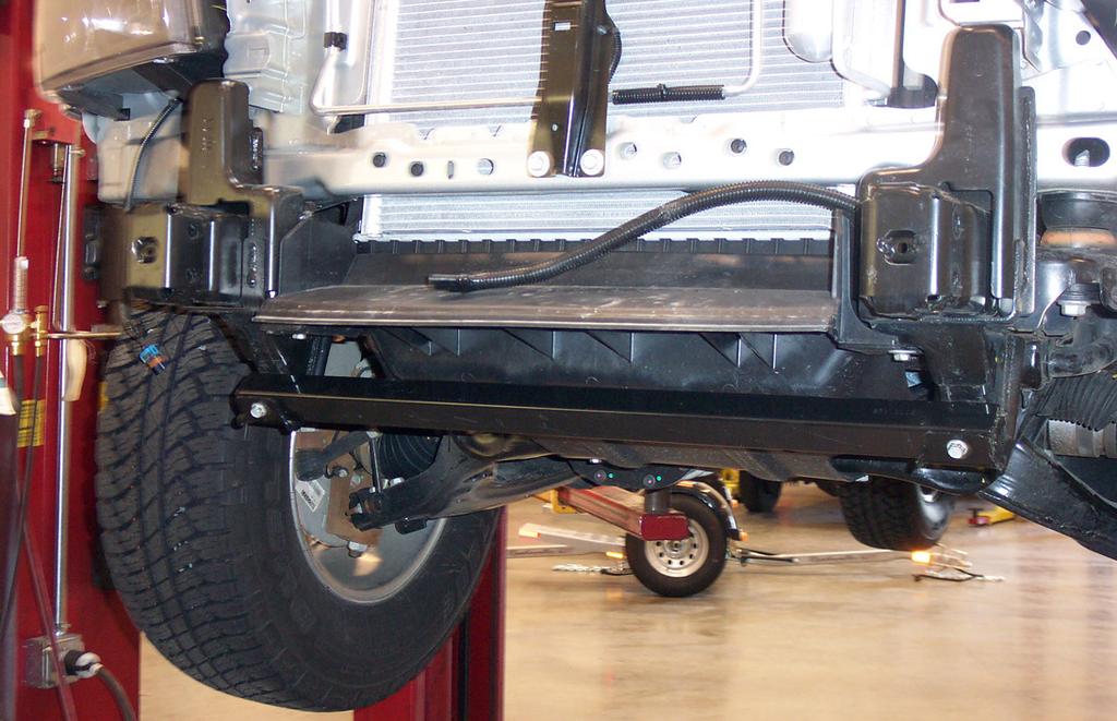 Now, remove the tow hooks from the ends of the frame rails, if the vehicle is so equipped.