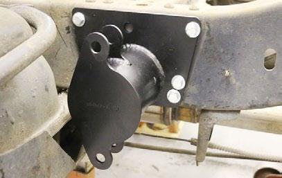 Sit an Upper Bar Mount on top of the axle with the locating pin into the center hole of the leaf spring pad.