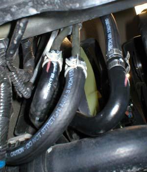 12) Find the hose coming from the upper fitting of the transmission cooler and route it to the
