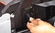2 Pull the buckle retainer through the slots in the cover and child seat shell to the bottom