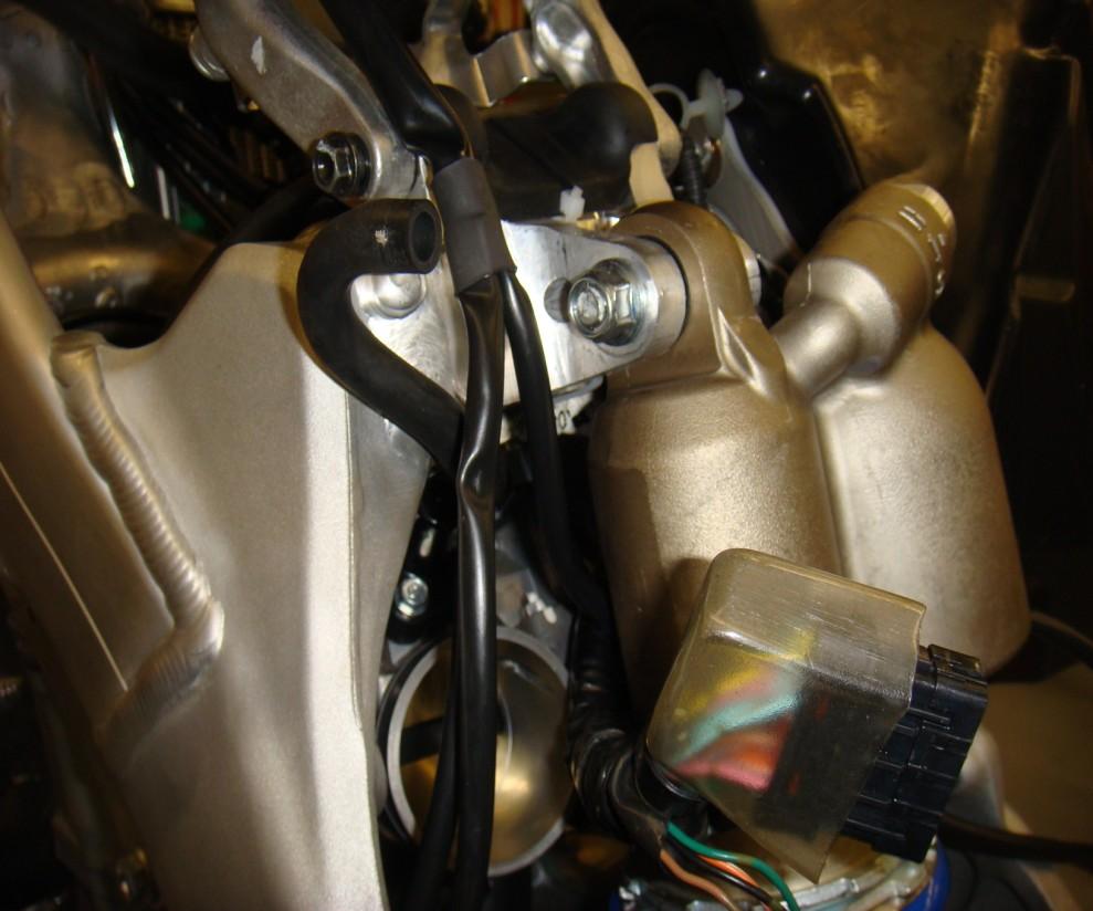 Raise the subframe (refer to service manual) and route the harness back into the airbox.