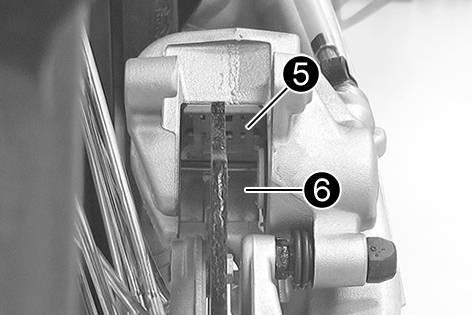 Make sure when pushing back the brake piston that you do not press the brake caliper against the spokes.