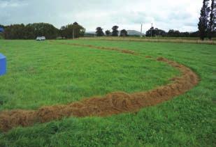channels feed onto the belt Feeds round bales in a long,