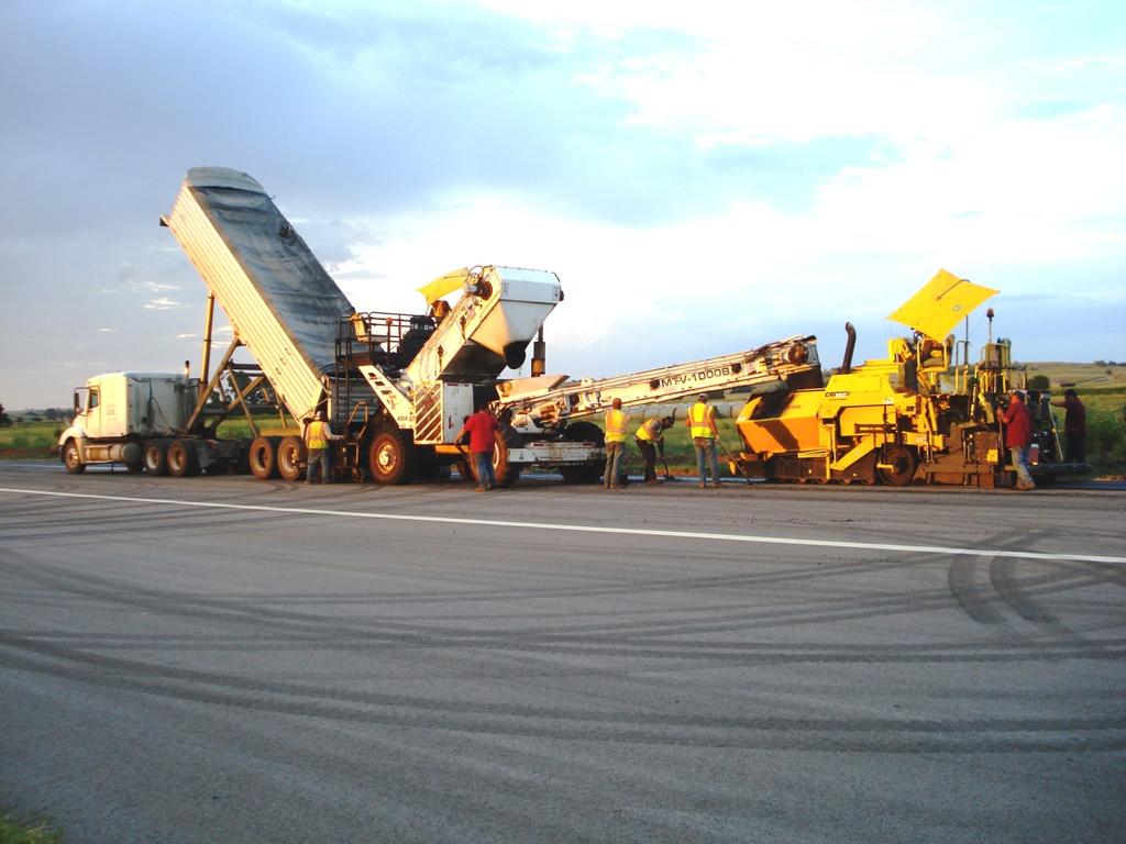 Figure 6.3. Paving Train Placing Shoulder Mix Warm mix technologies can be used to reduce production temperatures, increase haul distances and improve compaction.