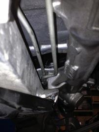 4. Unbolt the steering rack using a 16mm wrench and an
