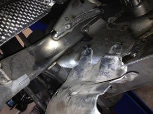 Remove the steering rack heat shield using the T25 TORX