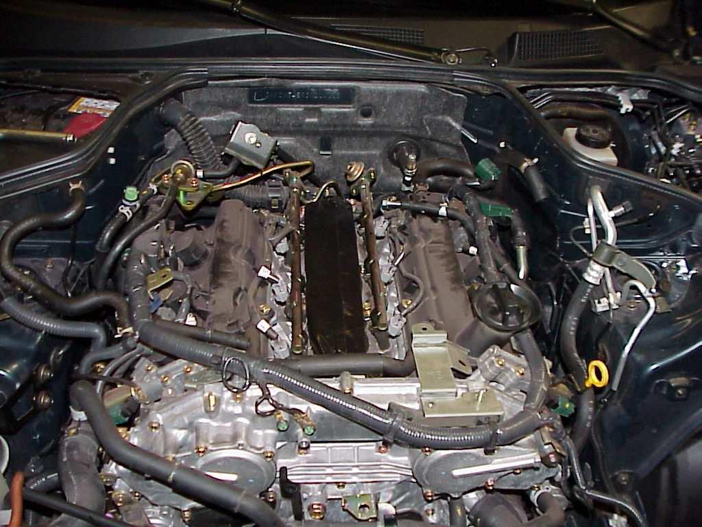 The two harness brackets pointed out will be removed and not reused. (Fig. 5). 12. On the front of the timing cover there is a long rubber bypass hose that goes from left to right of the engine.