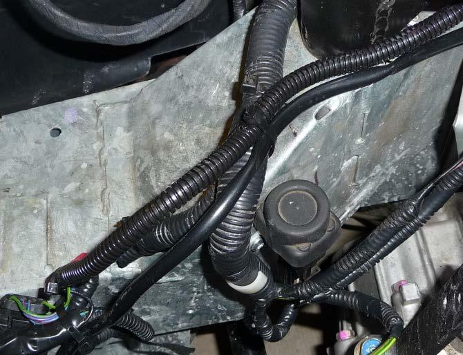 Install the ring terminal wire from the FST harness and replace the nut. Tighten the nut and snap the cover closed. 7.