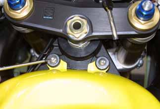 Please unscrew the 2 hex screws located on the right and left side of the bike as shown in Figure 9.