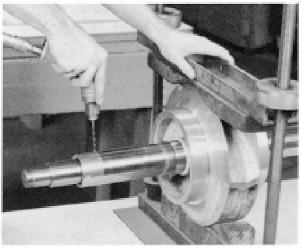 spanner wrench and hammer, securely tighten the shaft sleeve nuts. Then drill a 3/16" diameter shallow recess in the shaft through the set screw hole in each of the shaft sleeve nuts.