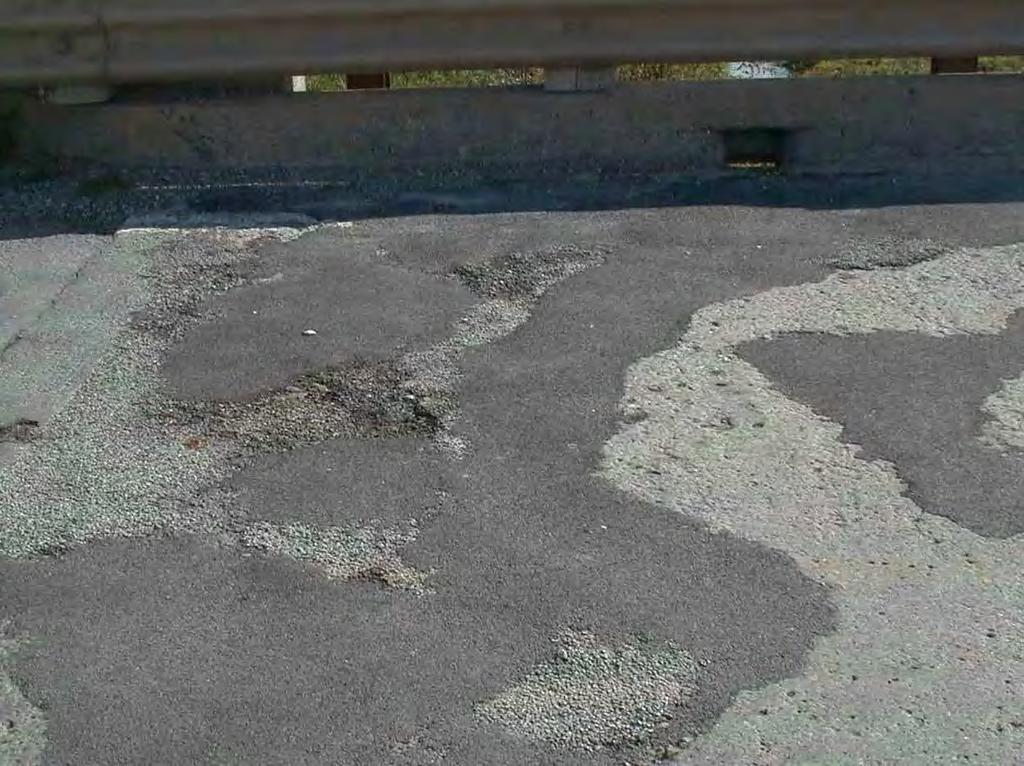 Figure 6.2. Asphalt Patches in CCB Concrete Deck. The superstructure, a cross section of which is shown in Figure 5.