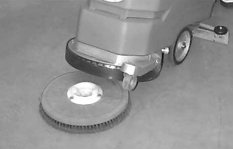 Secure pad with plastic centerlock ring (Figure 11). FIG. 13 6. Release the brush lift pedal from transport position while holding scrub head off pad driver (Figure 14). FIG. 11 4.