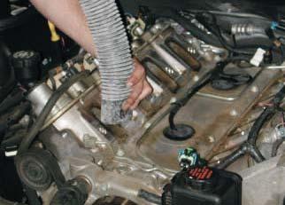 80. Using a vacuum cleaner, remove any dirt or debris from the intake port area.
