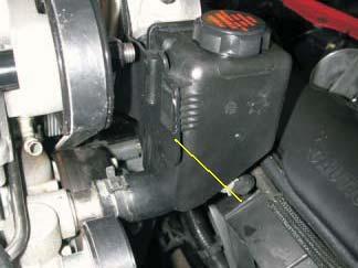 123. Install the power steering reservoir to the reservoir bracket, then route