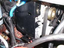 Attach the compressor bracket (D) to the passenger-side of the alternator by installing a countersunk bolt (O) into the wiring loom boss with the spacer (E) between the compressor bracket (D) and the