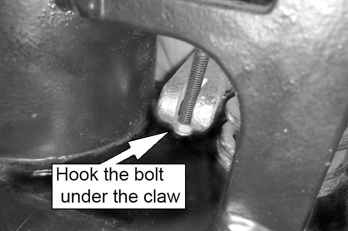 Push and hold the screw adjuster inwards to raise the end of the forked lever. 5.