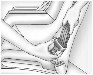 Seats and Restraints 3-49 3. Pick up the latch plate, and run the lap and shoulder portions of the vehicle's safety belt through or around the restraint.
