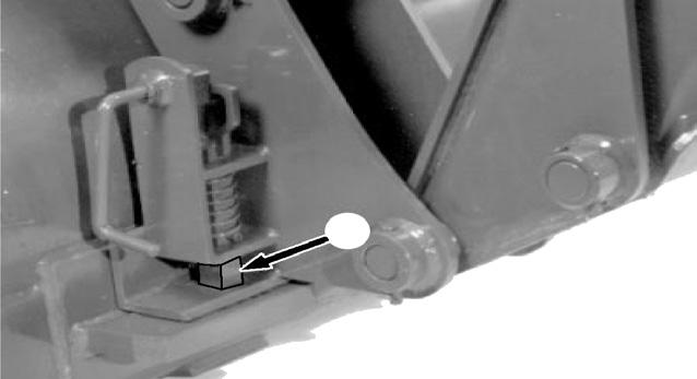600/700 - Drive forward, adjusting loader height and position until the top of the bracket is aligned with the pins (A).