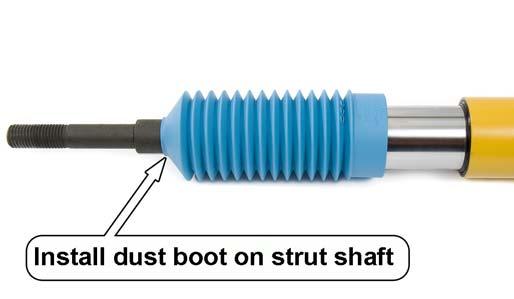 7. From the top of the strut tower, remove and discard the thrust washer, the top rubber bushing and the crush sleeves