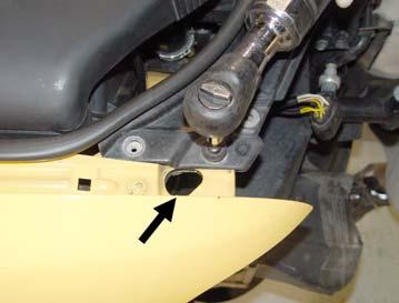 Step 4: Remove both headlights. There are two T30 torx bolts each on top, and one in the access hole at the arrow in Figure 4.