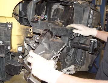 Pulling the radiator support outwards away from the front of the car will give more room to do so.
