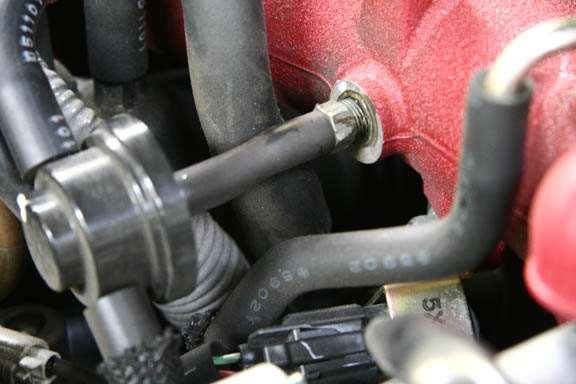 39. Locate the OEM engine breather return hose located in
