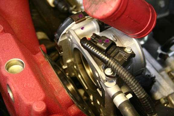 16. Tap the top of the throttle body to break it free