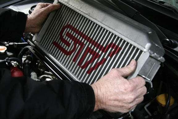 Carefully pull the intercooler up and out of the engine bay.