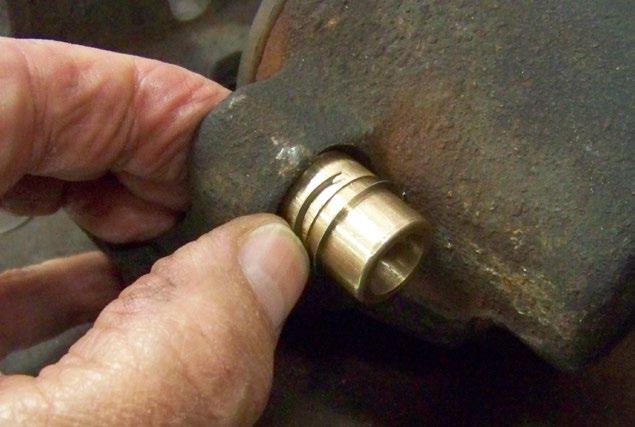 It is easiest to open the end of the clip slightly and spiral it over the bushing as shown in the photo.