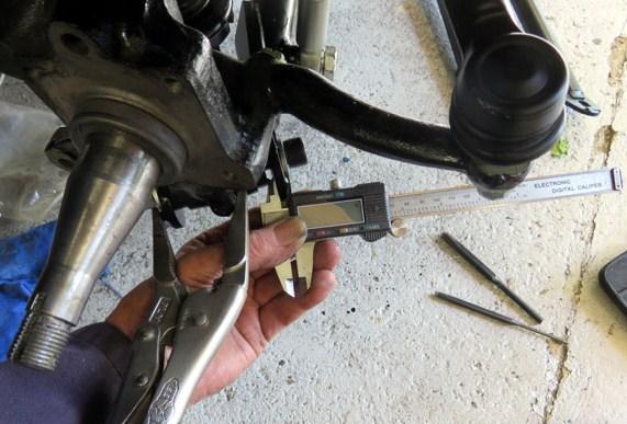 At the bottom of the front trunion where the front and rear lower swinging arms bolt together to form the lower wishbone there is an opportunity to fine tune the