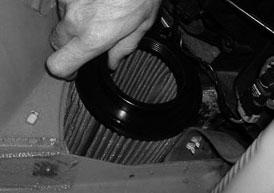 Once the horn bracket is removed, lower the air filter into the triangular shaped hole that is left behind. If your car is equipped with headlight sprayers the fit will be very tight.