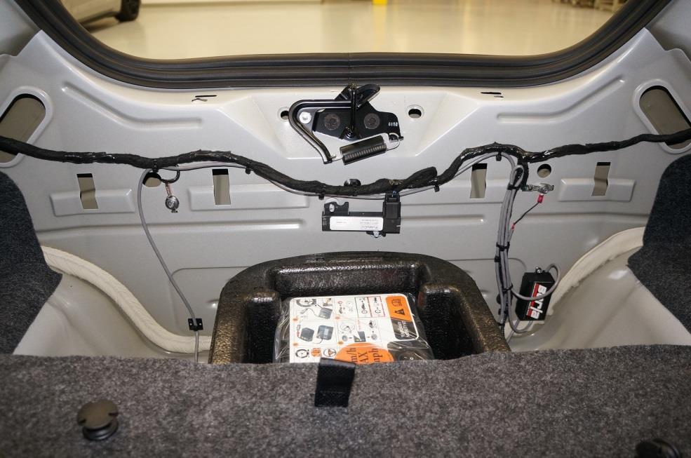 10. With the wiring secured beneath the Vehicle, you can now finish tying back the wires inside the trunk.
