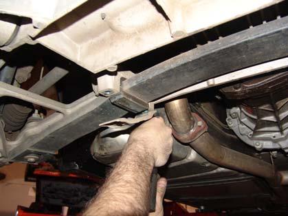 We will also have to remove the tie rod end from the rear like we did in the front as well. Figure 7a and 7b Removal of lower shock bolt and tie rod.