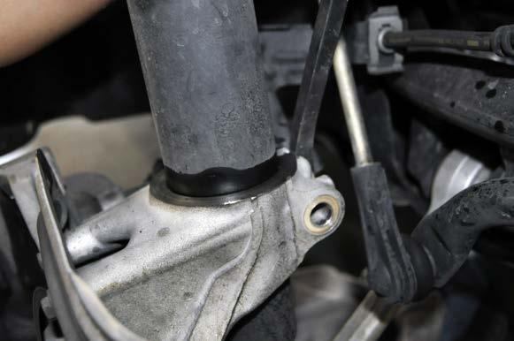 hold the rubber cover down over the strut/strut bar